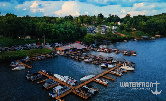 An aerial image of boats on the water at Buckeye Lake showing the front of the Waterfront on Buckeye Lake bar and restaurant.