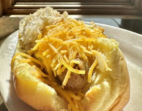 Photo of a hot dog with cheddar cheese on it from Hometown Hot Dogs