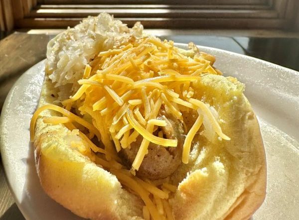 Photo of a hot dog with cheddar cheese on it from Hometown Hot Dogs