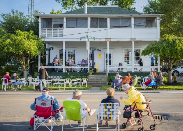 Photo of many people sitting outside of Weldon's Ice Cream Factory.