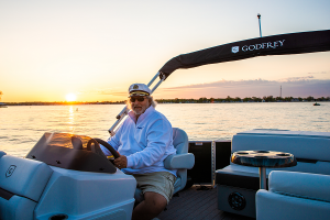 man on a pontoon with sunset