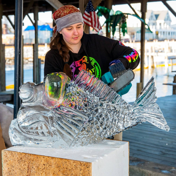 Girl carving ice sculpture.