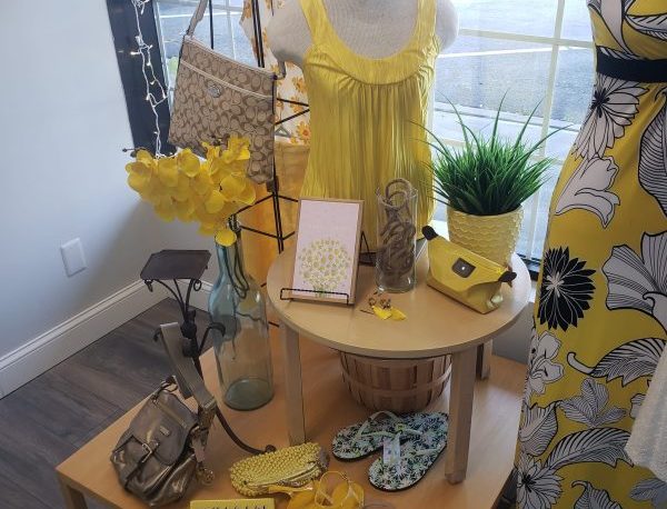 Photo of a bright yellow sundress and accessories sold at the Yellow Sundress Resale Boutique.