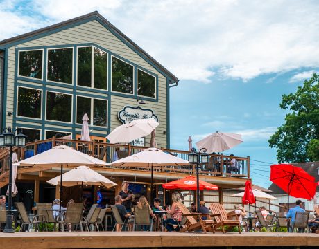 Photo of a large patio with seats and umbrellas.