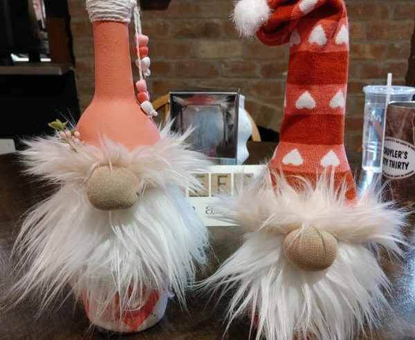 Photo of wine covers that are decorated as gnomes.