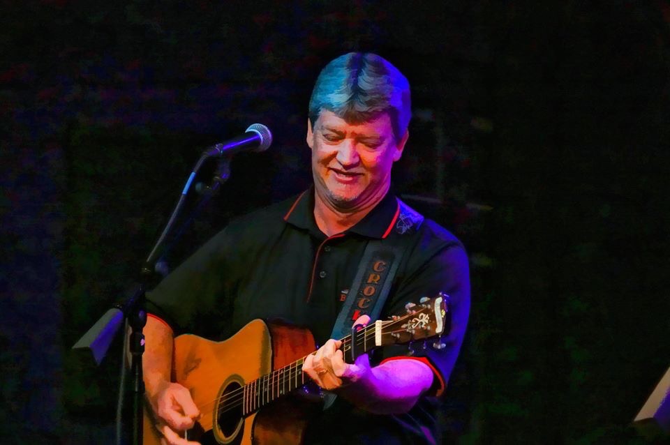 Musician Danny Lang singing and playing guitar.