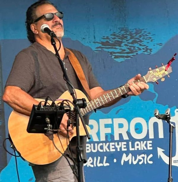 Photo of musician AJ Angelo playing guitar