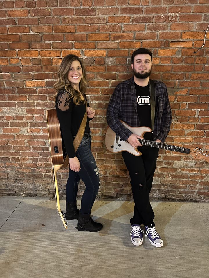 Photo of band Allison Road Acoustic in front of a brick background.