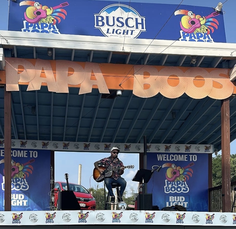 Photo of musician Chase Duncan playing on a stage