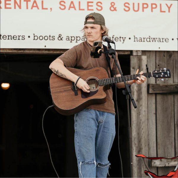 Photo of musician Kade Dennison playing guitar