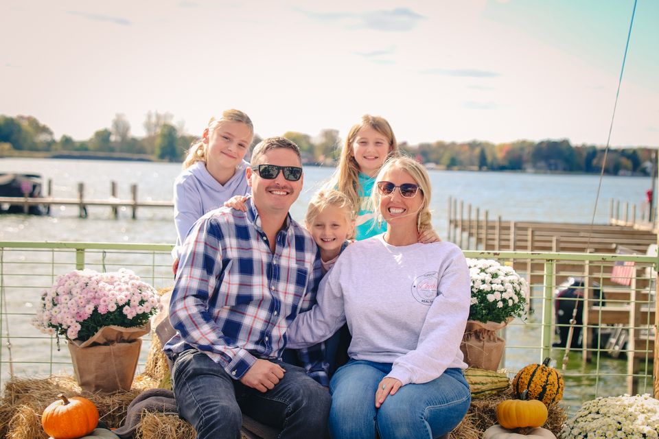 Photo of a family posing in front of a lake