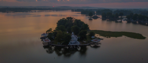 Aerial image of a house on an island during sunset.