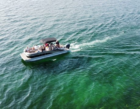 wide view of the lake with a pontoon boat